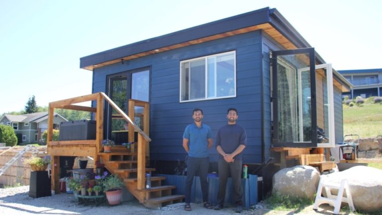 Rohan and Salik standing in front of single story Lotus Mini Prefabricated home